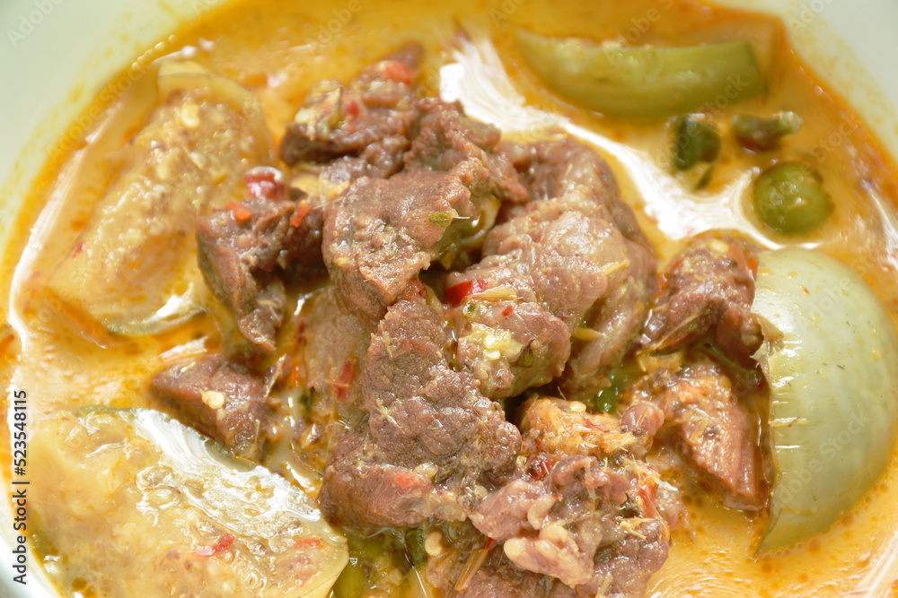 spicy boiled beef meat with eggplant in coconut milk green curry soup on bowl spicy boiled beef meat with eggplant in coconut milk green curry soup on bowl