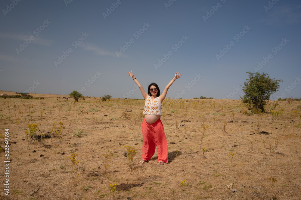 outdoors lifestyle portrait of young happy and beautiful Chinese woman enjoying summer holiday while pregnant proud of her belly as mother expecting baby concept outdoors lifestyle portrait of young happy and beautiful Chinese woman enjoying summer holiday while pregnant proud of her belly as mother expecting baby concept