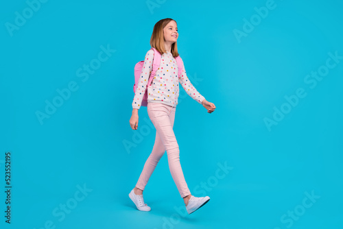 Photography Full length photo of charming pretty small girl wear dotted shirt backpack walki