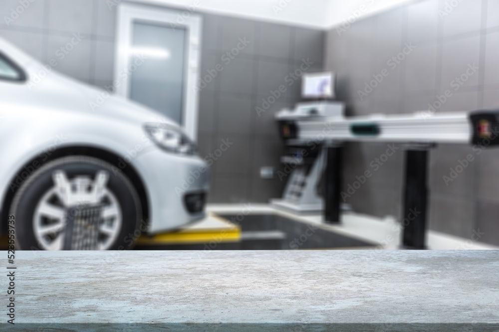 Empty table top with car service centre auto repair workshop blurred background Empty table top with car service centre auto repair workshop blurred background
