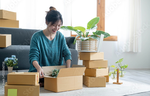 Young woman small business owner working at home office. Online marketing packaging delivery, startup SME entrepreneur or freelance woman concept. Small business owener photo