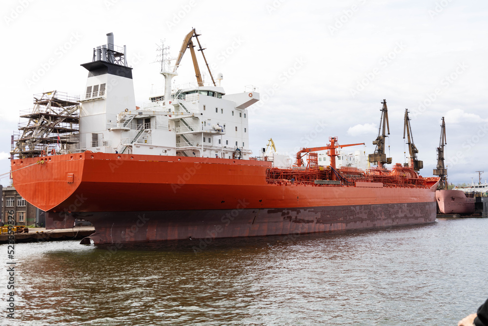 oil tanker unloading big ship in shipyard