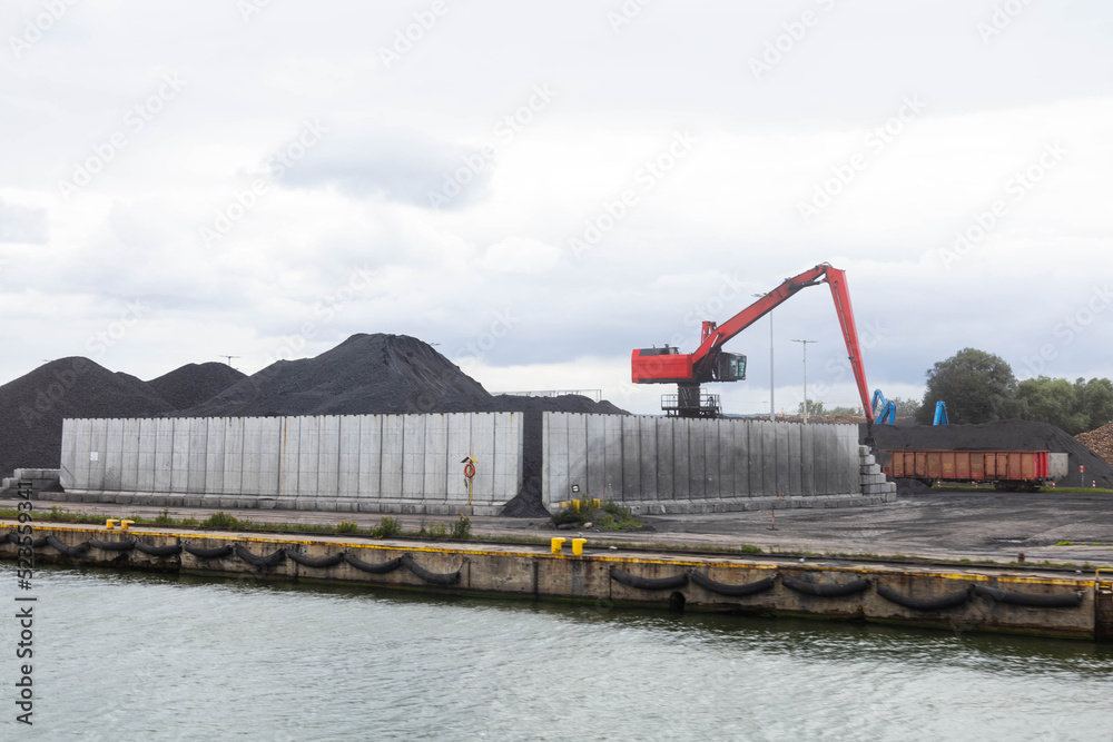coal unloading in polish shipyard, coal shortage Mountains of coal on the territory of the Poland Commercial Sea Port. The unloading of wagons 