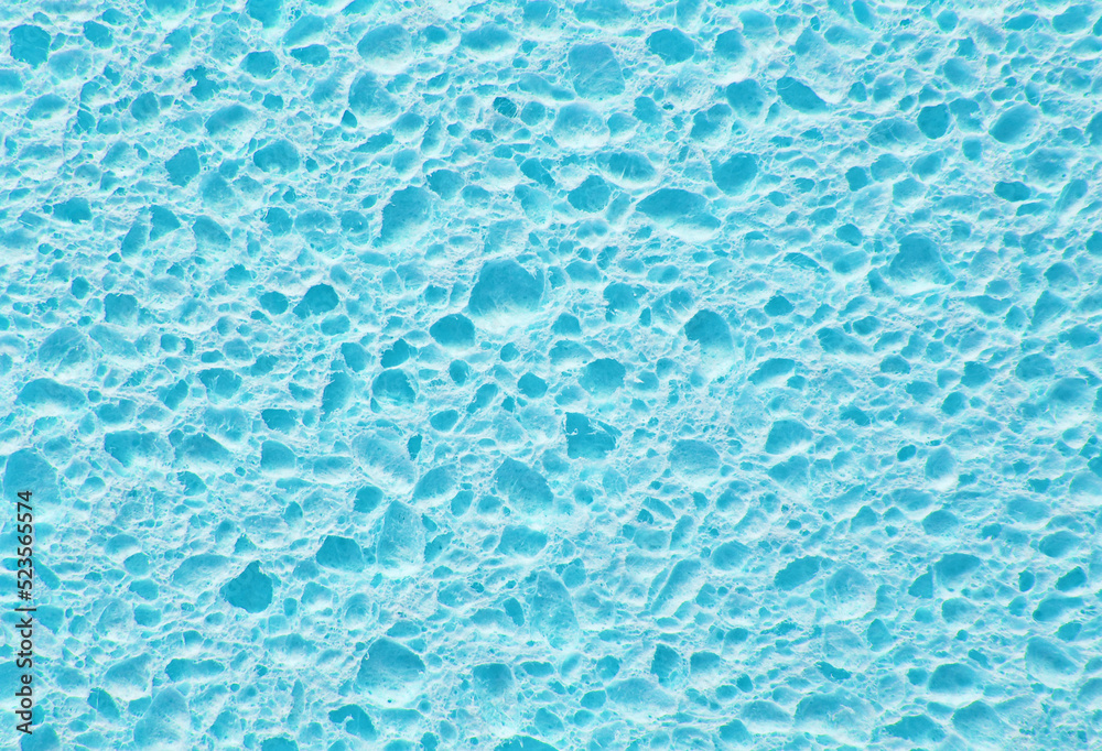 Light blue color porous cleaning sponge texture as background