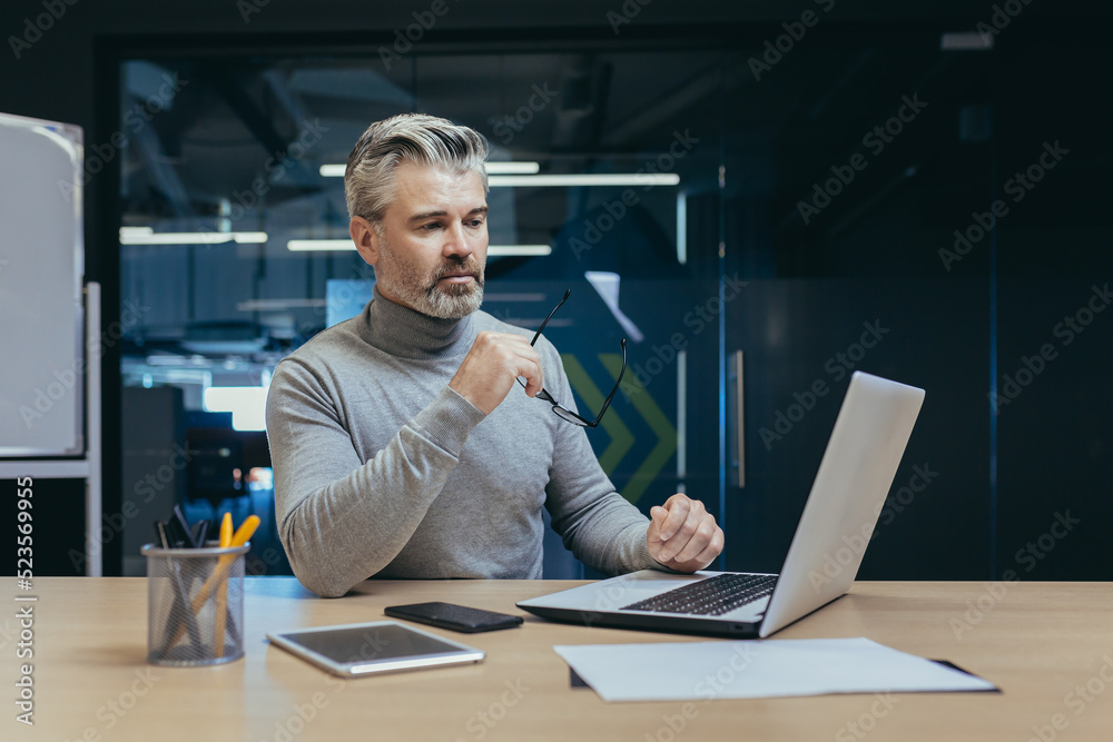 Successful and serious owner senior gray-haired investor mature businessman working in modern office using laptop, man thinking about business strategy, Successful and serious owner senior gray-haired investor mature businessman working in modern office using laptop, man thinking about business strategy,