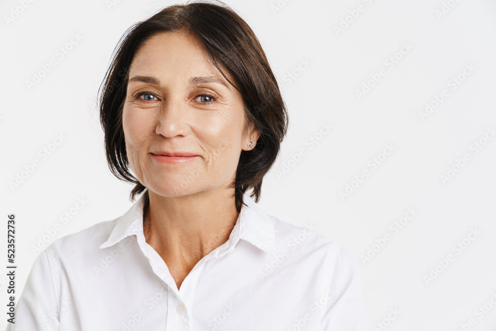 Mature brunette woman smiling and looking at camera Mature brunette woman smiling and looking at camera
