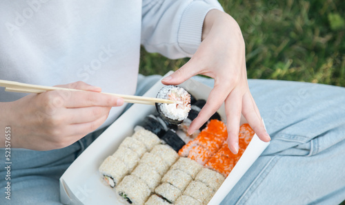Close up of sushi in box at picnic, sushi delivery concept.