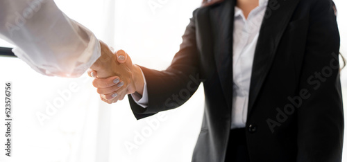 Businesspeople or lawyers shaking hands finishing up meeting or negotiation in the office. Business handshake and partnership