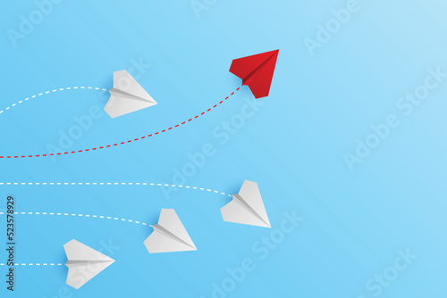 Creative paper planes on blue background. Think differently concept. Red airplane changing direction. New idea, change, trend, courage, creative solution, innovation and unique concept.