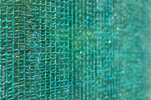 Knitted polyethylene mesh background  sun protection material that creates shade danger of solar overheating concept