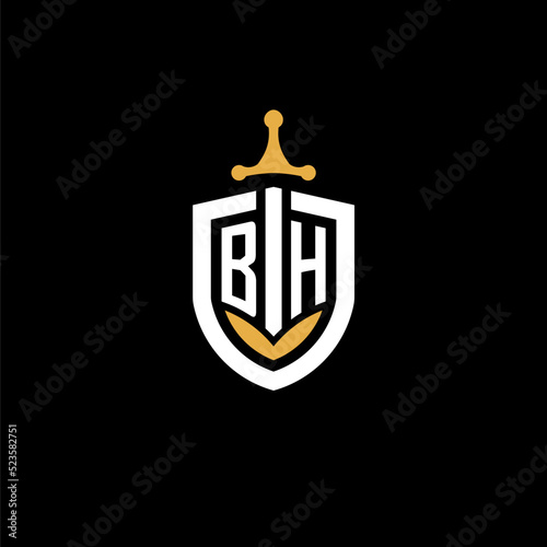 Creative letter BH logo gaming esport with shield and sword design ideas photo