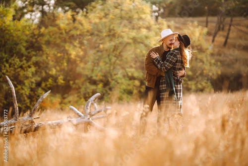 Lovely hipster couple resting in nature. People, lifestyle, relaxation and vacations concept. Autumn Fashion, style concept.