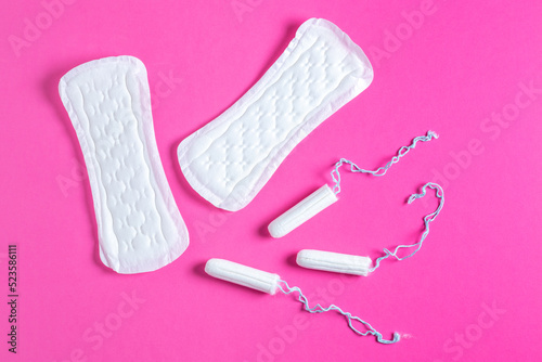 Menstrual tampons and pads on a pink background. Menstruation cycle. Hygiene and protection.