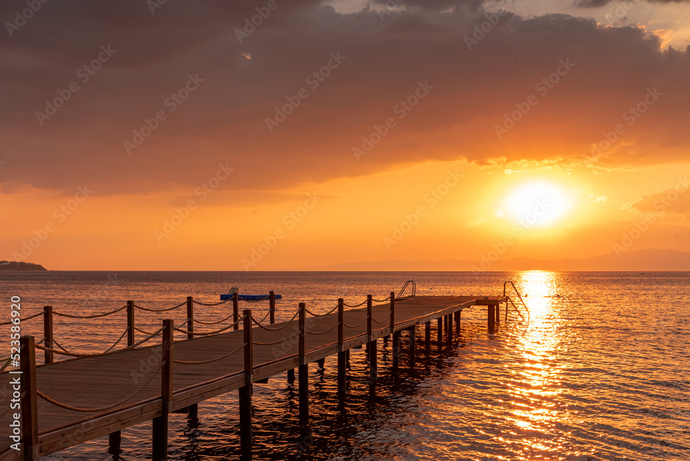 sunset pier in the sea 