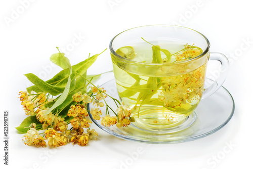 Cup of herbal tea with linden flowers on a white background