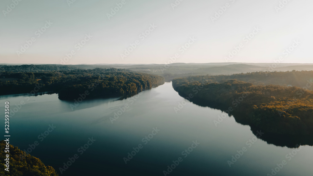 Aerial Photo of a large river surrounded by lush forests in New York. 