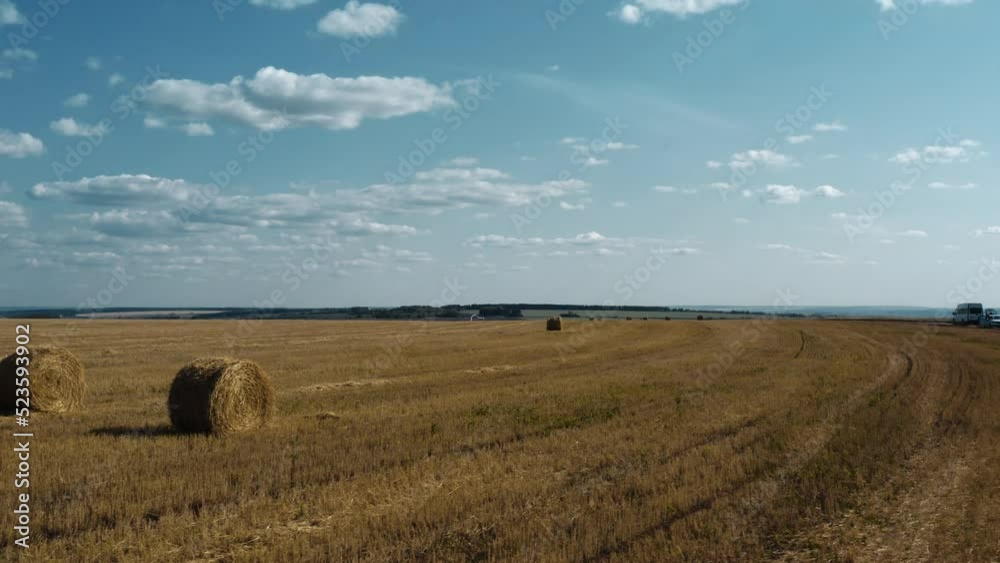 Haystacks on a yellow wheat field. Crop is harvested. The camera is moving to the right. Top view. 4K Haystacks on a yellow wheat field. Crop is harvested. The camera is moving to the right. Top view. 4K