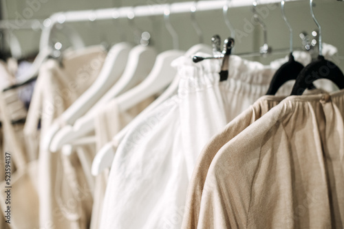 Sustainable fashion, slow fashion. Close Up Shot of Clothing Rack with natural tones clothes