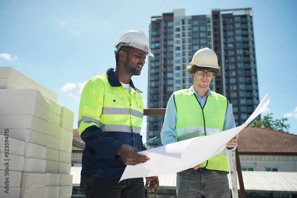 Architect and construction engineer or surveyor discussion plans and blueprints Architect and construction engineer or surveyor discussion plans and blueprints
