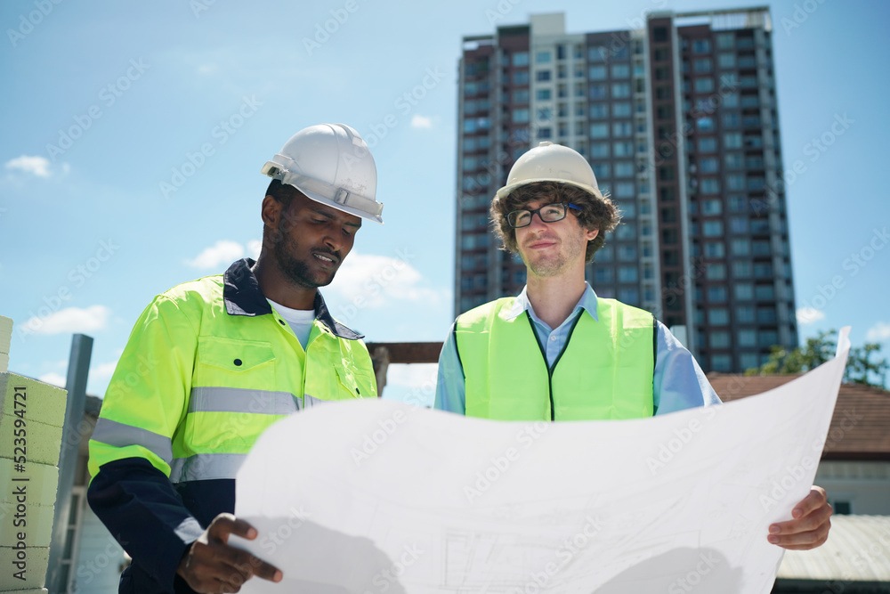 Architect and construction engineer or surveyor discussion plans and blueprints Architect and construction engineer or surveyor discussion plans and blueprints