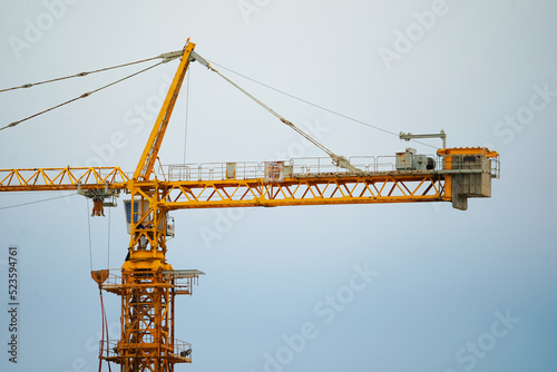 Wallpaper Mural Construction crane against the blue sky and the houses under construction Torontodigital.ca