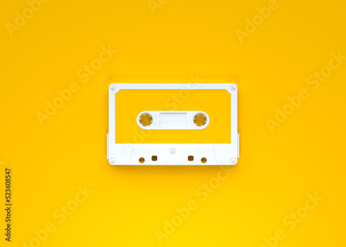 Vintage audio tape cassette on a yellow background. Top view with copy space. 3d rendering illustration