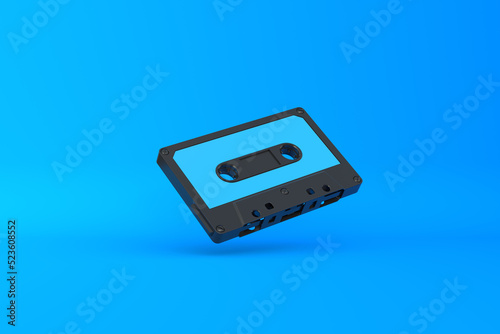 Vintage audio tape cassette on a blue background. Front view with copy space. 3d rendering illustration