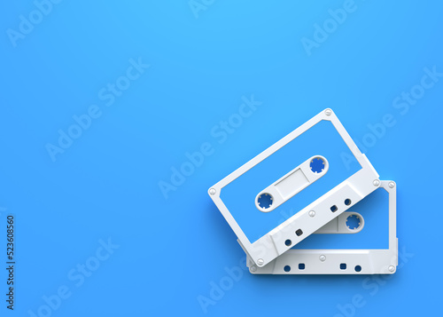 Two vintage audio tape cassettes on a blue background. Top view with copy space. 3d rendering illustration