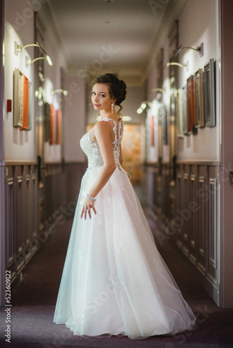 Charming bride posing in the hallway in hotel