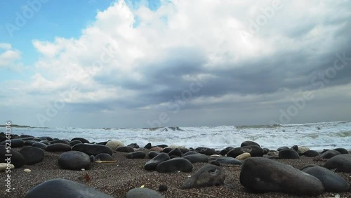 An impressive sea storm. Sea waves rush onto the sandy shore of black volcanic sand, creating an explosion of water. Without people.