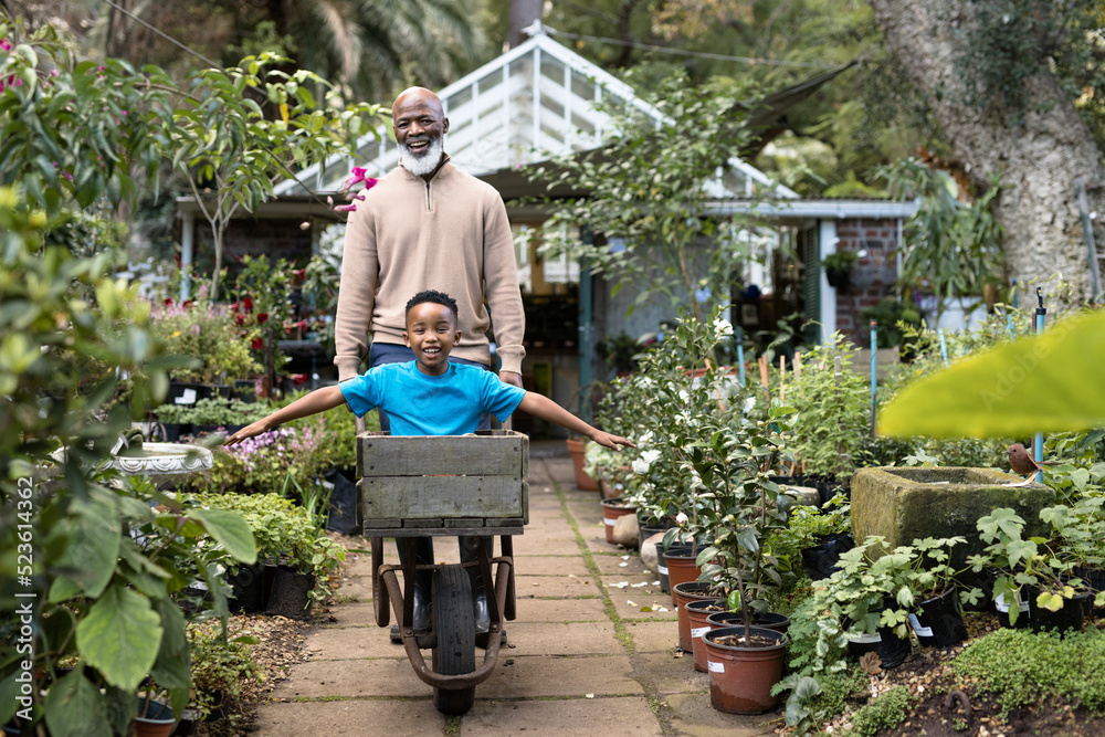 Portrait of happy senior african american man with his grandson in garden Portrait of happy senior african american man with his grandson in garden