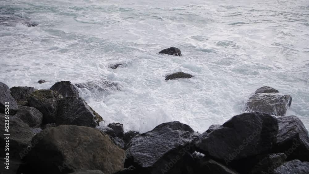 waves in the ocean beat against stones waves in the ocean beat against stones