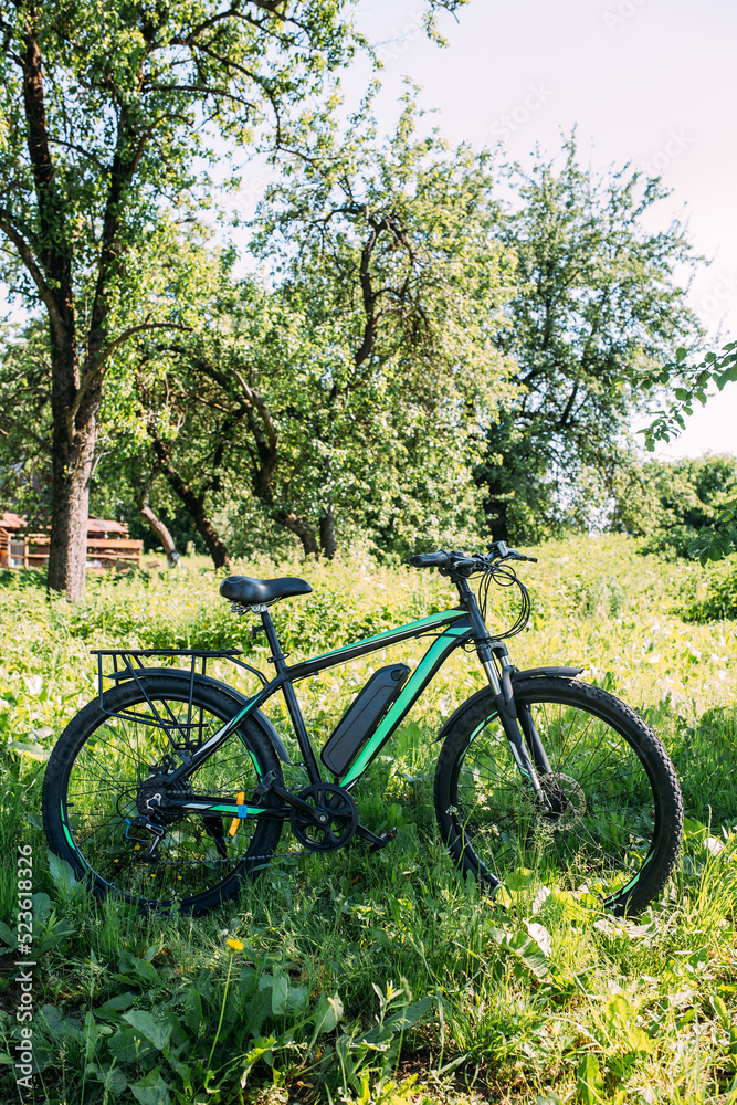 Electric bike in summer on a sunny day. E-bike is a modern hybrid vehicle