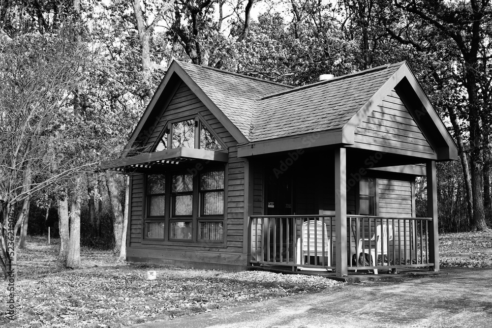 A wooden Cabin sits beside a quiet forest during the autumn A wooden Cabin sits beside a quiet forest during the autumn