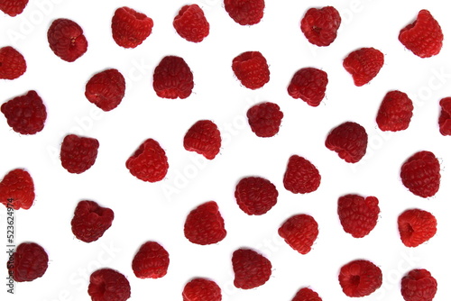 Background of ripe red raspberries on a white background.