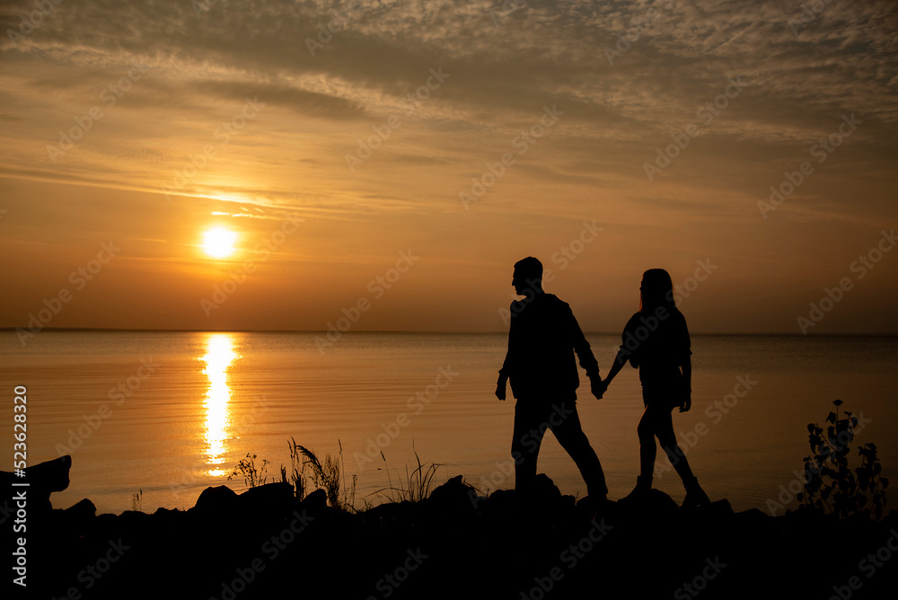 silhouette of a couple on the beach at sunset