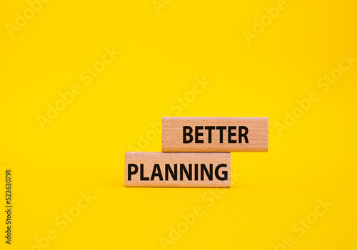 Better planning symbol. Concept word Better planning on wooden blocks. Beautiful yellow background. Business and Better planning concept. Copy space photo