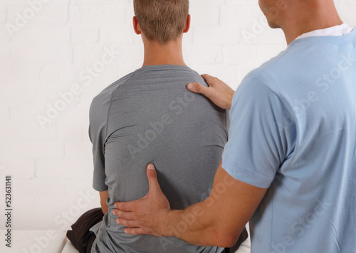 Adolescent Back Pain. Scoliosis spine curvature. Doctor and teenage patient