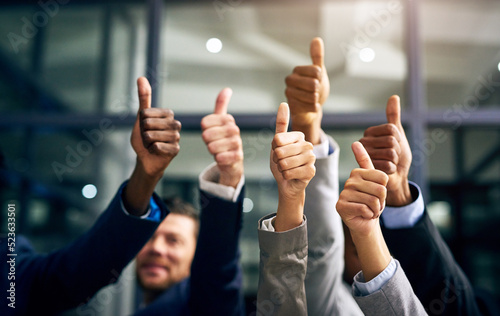 Thumbs up with hands of a business team or group giving their approval, saying thank you or giving motivation together in their office at work. Corporate professionals supporting with trust