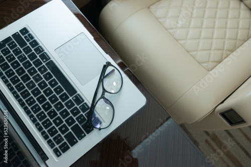 Private Jet interior with computer and glasses - business mood 