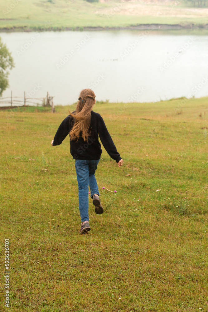 The girl runs across the glade