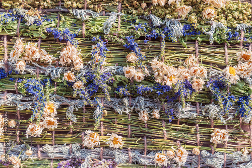 Decorative weaving from dried flowers and herbs, background.