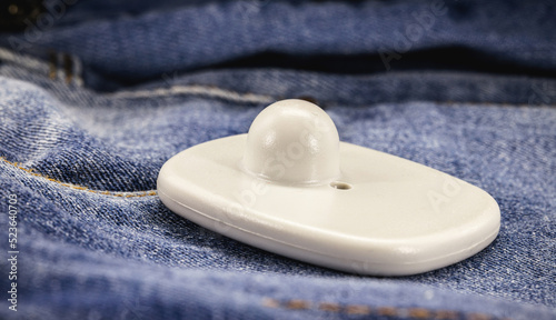 anti-theft tag or tag, security tag with sensor and electronic warning, electronic security equipment, on denim clothing