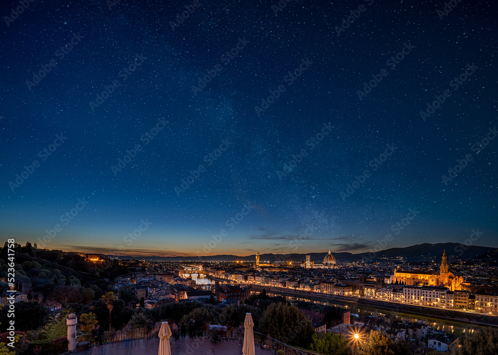 Night time image of stars over the illuminated city of Florence, Italy