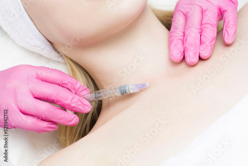 Injection in the face at the spa salon. The doctor s hands. Biorevitalization. Facial care with hyaluronic acid.