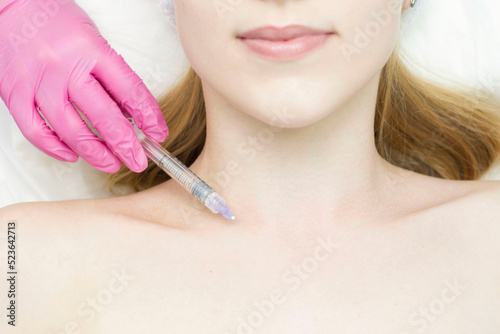Injection in the face at the spa salon. The doctor's hands. Biorevitalization. Facial care with hyaluronic acid.