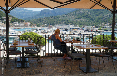 Harbour side restaurant with boat and marina in background. © harlequin9