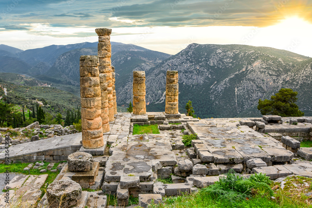 The setting sun highlights the ancient ruins and columns at the sacred ...