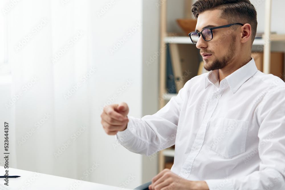 handsome businessman wearing glasses sits at a desk office worked executive handsome businessman wearing glasses sits at a desk office worked executive