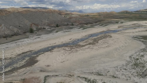 Aerial-Descending-Reservoir reduced to trickle of water that once was a river through an otherwise dry lake bed by extended drought afflicting the entire Western U. S.